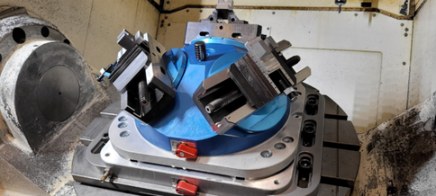 Detail of zero-point fixture clamping on a CNC machine.